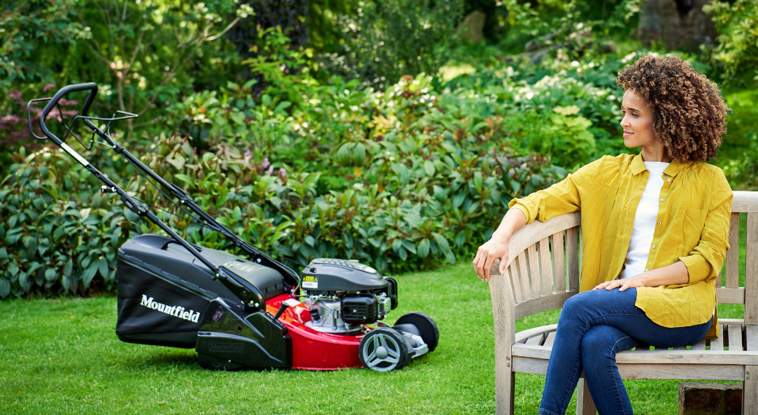 WOMAN SITTING ON CHAIR WITH MOUNTFIELD LAWNMOWERS