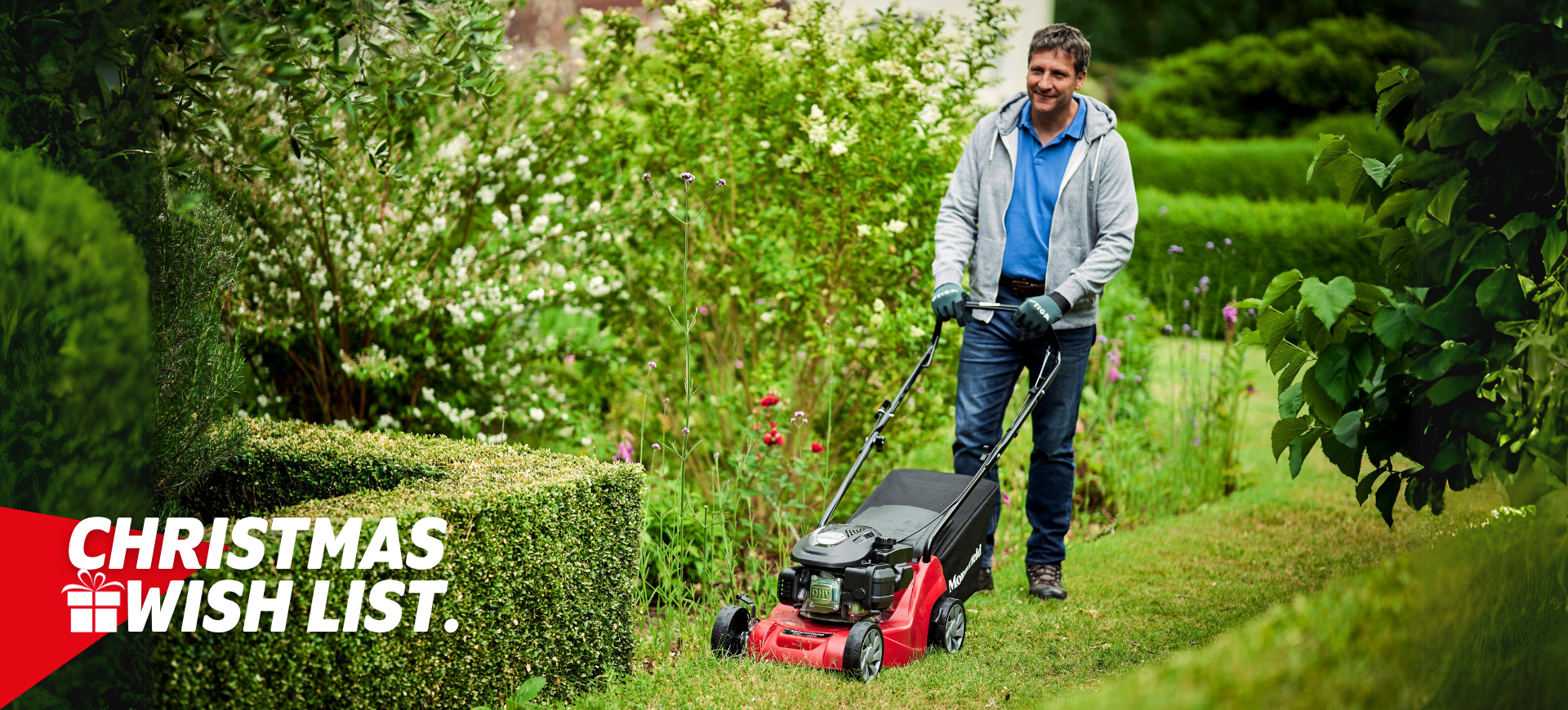 man mowing lawn with mountfield lawnmower