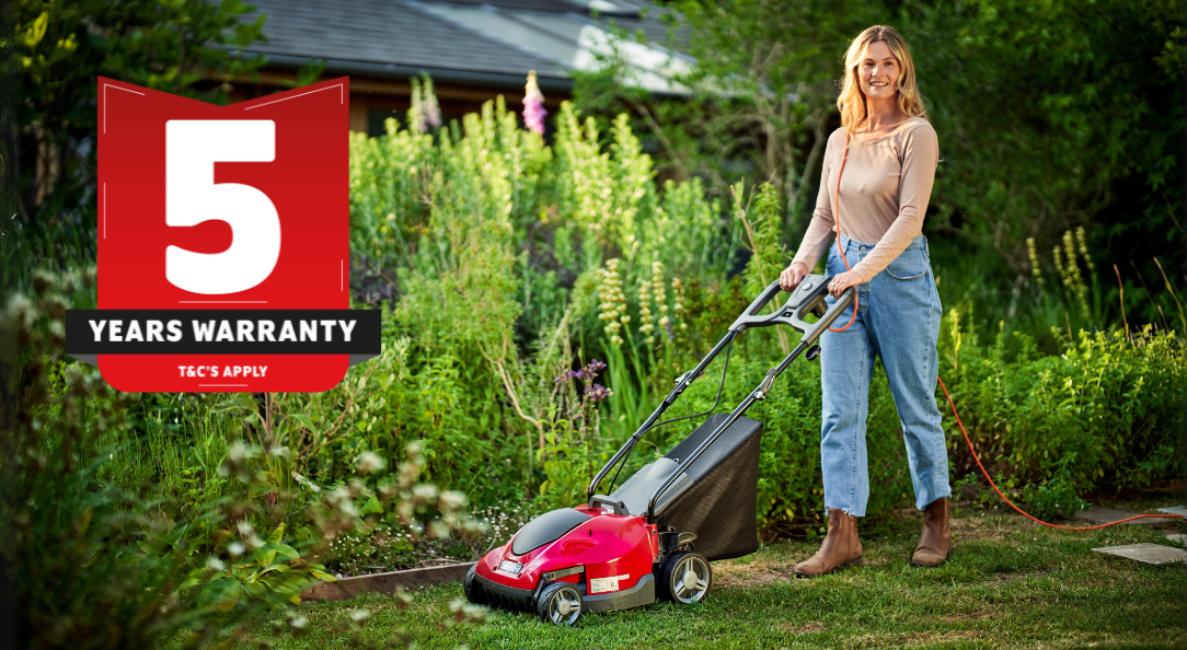 WOMAN MOWING LAWN WITH MOUNTFIELD ELECTRIC MOWER